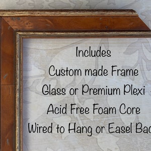 May include: A close-up of a wooden picture frame with a gold trim. The frame is made of wood and has a glass or plexiglass front. The frame is also acid-free and has a foam core. The frame is wired to hang or has an easel back.  Includes: Custom made Frame, Glass or Premium Plexi, Acid Free Foam Core, Wired to Hang or Easel Back