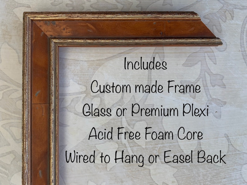 May include: A close-up of a wooden picture frame with a gold trim. The frame is made of wood and has a glass or plexiglass front. The frame is also acid-free and has a foam core. The frame is wired to hang or has an easel back.  Includes: Custom made Frame, Glass or Premium Plexi, Acid Free Foam Core, Wired to Hang or Easel Back