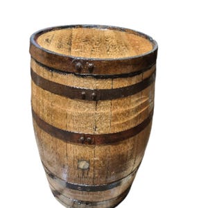 May include: A wooden barrel with a light brown finish and dark metal bands. The barrel has a rounded top and is made of wooden planks. The metal bands are secured with rivets. The barrel is likely used for storage or decoration.