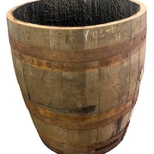 May include: A vintage wooden barrel with metal hoops. The barrel is made of aged wood with visible grain and knots. The interior is dark, and the exterior shows signs of wear. The metal bands are rusty. The barrel has a wide opening and a cylindrical shape.