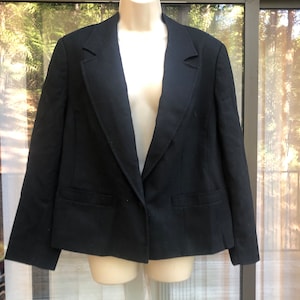 May include: A black blazer with a single button closure and a notched collar.