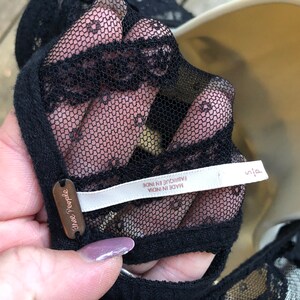 May include: Black lace top with a Free People tag and a white label that reads "Made in India, Fabrique en Inde".