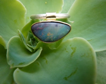 Ring, handmade in silver and gold with a triangular boulder opal