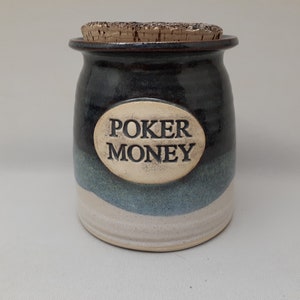 May include: A blue and white ceramic jar with a cork lid. The jar has the words "Poker Money" written on it.