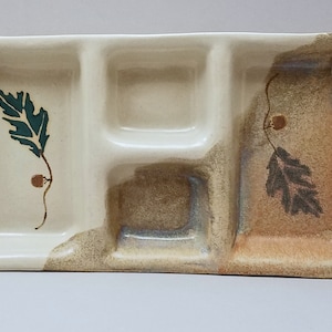 May include: A ceramic serving tray with three divided sections. The tray is decorated with a brown and green leaf design.
