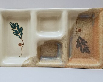 May include: A ceramic serving tray with three divided sections. The tray is decorated with a brown and green leaf design.