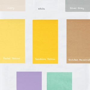 May include: A selection of rectangular colour swatches in shades such as ivory, white, silver grey, pastel yellow, sunshine yellow, golden hazelnut, lilac purple, and mint green. Each swatch has a colour name written in a handwritten font.