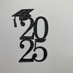 May include: Black glitter graduation cap and the numbers 2025. The graduation cap is above the number 20. The number 25 is below the number 20. The numbers and cap are black and glittery.