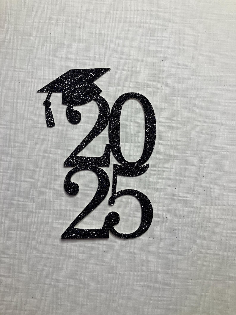 May include: Black glitter graduation cap and the numbers 2025. The graduation cap is above the number 20. The number 25 is below the number 20. The numbers and cap are black and glittery.