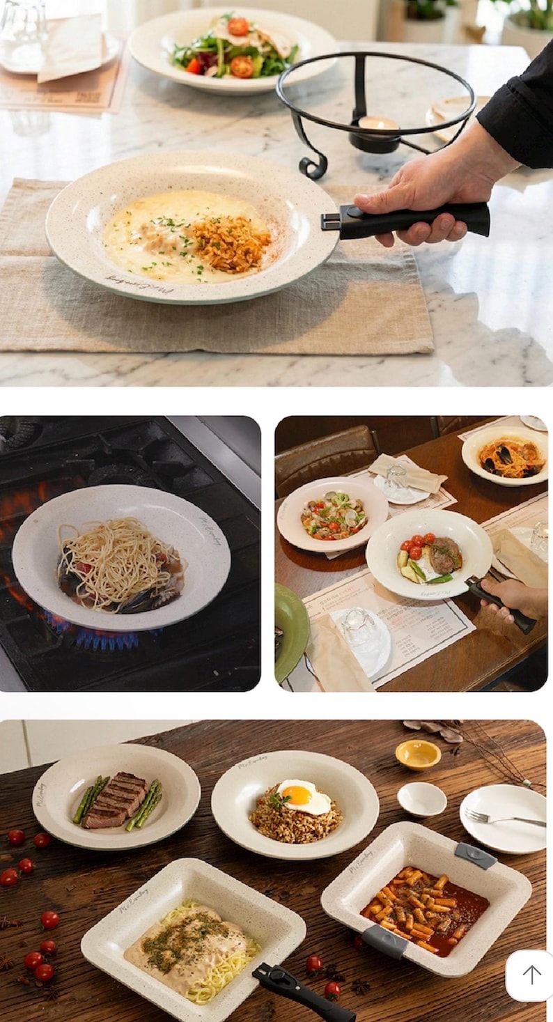 Puede incluir: Una colecci&oacute;n de platos y cuencos de cer&aacute;mica beige, algunos con comida, incluyendo pasta, bistec y ensalada. Algunos platos tienen un asa negra desmontable. Tambi&eacute;n hay un calentador de velas, lo que sugiere un tema de comedor o servicio.