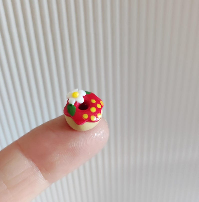 May include: A white ceramic mug with a black handle and the text "But First, Coffee" in a bold, black font. The mug is set against a neutral background, highlighting its simple design.