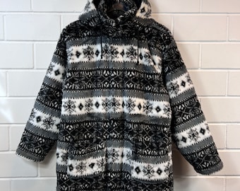May include: Black and white hooded fleece jacket with a geometric snowflake pattern.