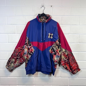May include: A blue, red and multi-coloured patterned jacket with a zip closure and a logo on the front.