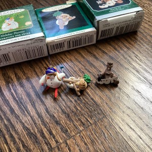 lot of three hallmark keepsake Christmas ornaments , snowman skiing 2001: sharing joy Rodney reindeer 1998 and woodland babies woodchuck 199