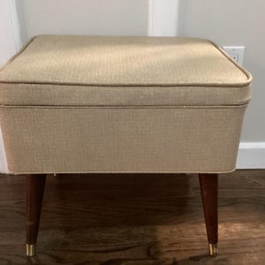 vintage sewing seat ottoman MCM vinyl beige hinged seat storage sewing basket wood legs