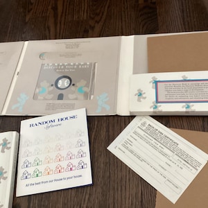 May include: An open book with the title "Discover Your Baby" and a Random House Software booklet. The book has a cover with a bear design. A back-up disk certificate is also visible.