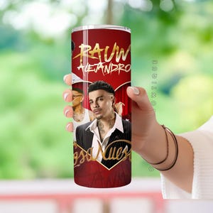 May include: A red and gold tumbler with a photo of a man with the text "Rauw Alejandro" and "Cosa Nuestra" on it.