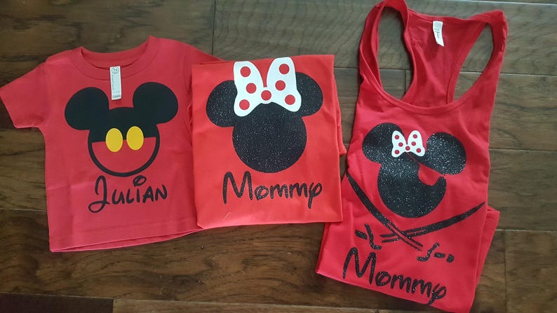 May include: Red shirts with a black and white Mickey Mouse and Minnie Mouse design. The shirts say "Julian" and "Mommy". A red tank top with a black and white Minnie Mouse design says "Mommy" with a glittery finish.