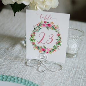 Set of 18 Silver Table number holders,  infinity bow table number holders