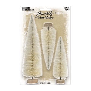 May include: Three decorative bottle brush trees in varying sizes. The trees are white with a touch of gold and sit on small wooden bases. The packaging includes the text "WOODLANDS REGIONS BOISÉES" and "ALPINE ALPIN".
