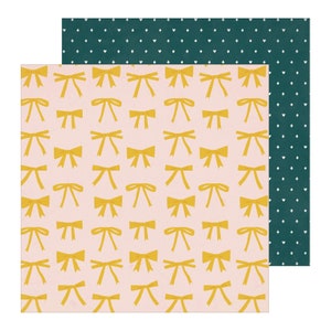 May include: A sheet of pink patterned paper with a repeating design of yellow bows. The paper is paired with a sheet of dark green paper with a repeating pattern of white hearts and crosses.