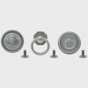 May include: Three pieces of antique-style hardware in a silver finish. The set includes two round knobs with detailed floral patterns and a ring pull with an octagonal backplate. Each piece has a matching screw.