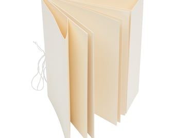 May include: A white blank book with a string closure. The book is open and the pages are fanned out.