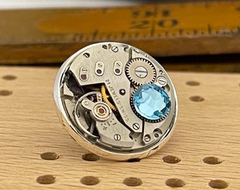Steampunk Lapel Pin Badge, With Watch Mechanics. Vintage Watch Movement with Aquamarine Crystal & Silver Plated Backing.