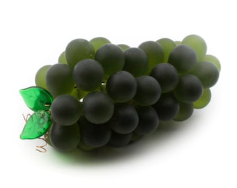 May include: A cluster of green glass grapes with a green glass leaf attached to a wire stem.