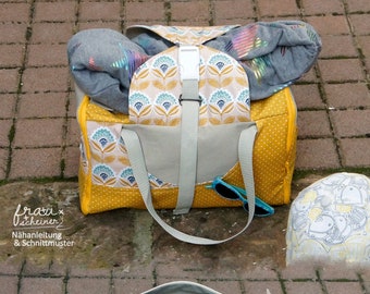 May include: A yellow and gray travel bag with a floral pattern and a zipper closure. The bag is open and a gray blanket and blue sunglasses are inside.