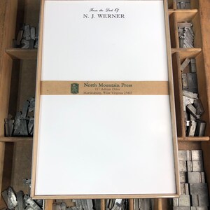 May include: A white card with a brown border and a brown label with the text "North Mountain Press, 117 Adrian Drive, Martinsburg, West Virginia 25403". The card also has the text "From the Desk Of, N. J. Werner" at the top.