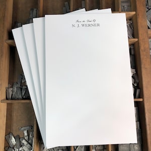May include: A stack of white letterhead stationery with the text "From the Desk Of N.J. Werner" printed in black ink.