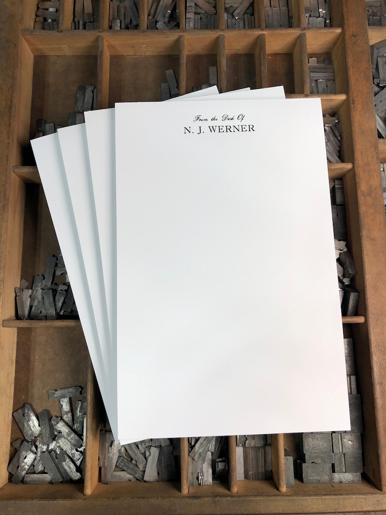May include: A stack of white letterhead stationery with the text "From the Desk Of N.J. Werner" printed in black ink.