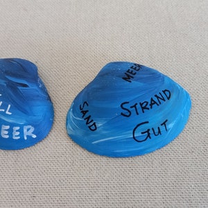 North Sea shell colored white blue - flotsam, lettering handwriting
