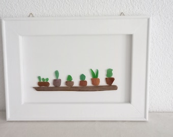 Green plants in pots - collage with seaglass, white canvas plate in the frame