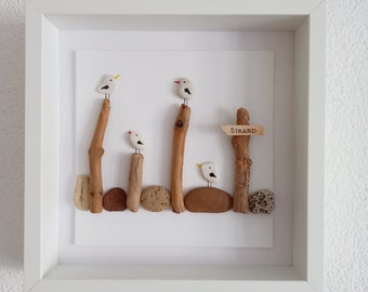 Seagulls on the wooden post ~ pebbles and driftwood in the object frame, to the beach