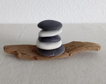 Balance stone sculpture on driftwood