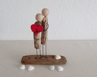 Driftwood heart man couple, red heart is the traditional and most recognized symbol of love and romance