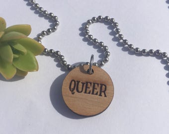 Smaller wooden 'QUEER' charm necklace.