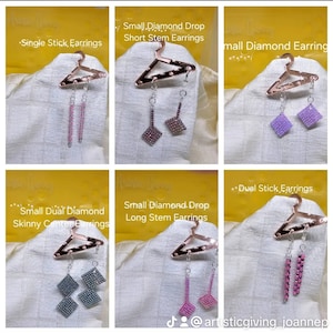May include: Six pairs of earrings displayed on a hanger. The earrings are made of small beads and come in a variety of colors, including pink, purple, and silver. The earrings are labeled with different names, such as "Single Stick Earrings", "Small Diamond Drop Short Stem Earrings", and "Small Dual Diamond Skinny Center Earrings".