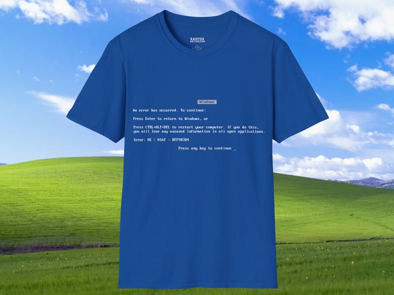 May include: A blue t-shirt with a white print of a Windows blue screen of death error message. The message reads: "An error has occurred. To continue: Press Enter to return to Windows, or Press CTRL-ALT-DEL to restart your computer. If you do this, you will lose any unsaved information in all open applications. Error: 0E: 011F: 87F1E304 Press any key to continue."