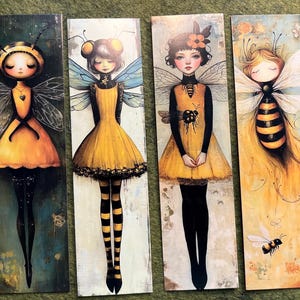 May include: Six rectangular art prints featuring stylized bee-themed figures in yellow and black dresses with wings. Each print has a unique design, with varying backgrounds and bee-related details, such as a sunflower or a bee on the head.