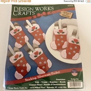 May include: A craft kit for making six felt stocking silverware pockets. The stockings are red with white accents, floral sequins, and heart details. The kit includes felt, trims, sequins, beads, cotton floss, needle, and instructions.