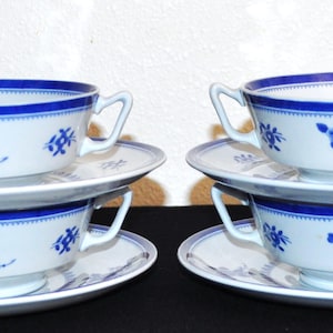 May include: Set of four blue and white porcelain soup bowls with matching saucers. The bowls have a floral design and a blue trim.