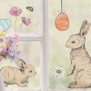 May include: Window decals featuring two brown bunnies, a bee, flowers, and Easter eggs. The bunnies are drawn in a vintage style.