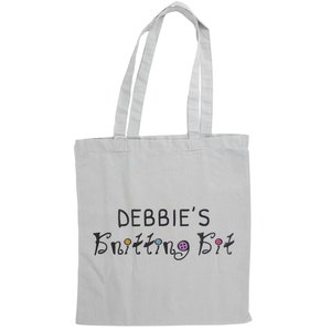May include: White canvas tote bag with black text that reads "Debbie's Knitting Bit" with colorful buttons around the text.