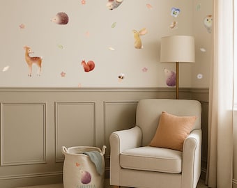 May include: A nursery scene featuring a beige armchair with an orange pillow, a round storage basket, and a wall decorated with watercolor animal decals. The basket has the name "Gabriella" printed on it.