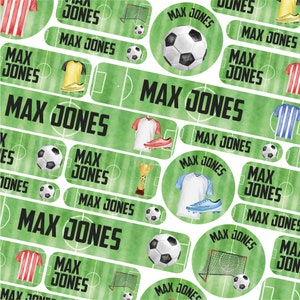 May include: A set of colorful, green, and white personalized name stickers with a soccer theme. The stickers feature a soccer ball, a soccer jersey, a trophy, and a soccer goal. The name "Max Jones" is printed on each sticker.