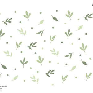 May include: A white background with a repeating pattern of green leaves and small green dots. The leaves are in various shades of green and are arranged in a random pattern.