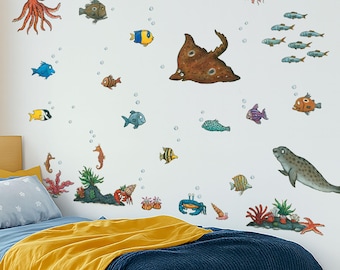 May include: A whimsical wall decal set featuring various sea creatures, including an octopus, fish, seahorses, and a seal. The colorful illustrations are set against a white background, with bubbles adding a playful touch. The decals are arranged to create an underwater scene.